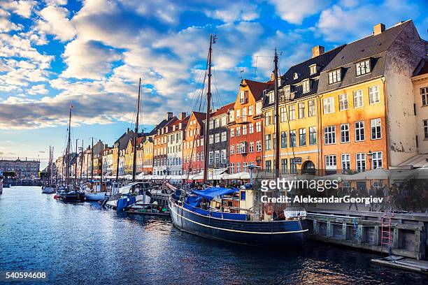 colorful traditional houses in copenhagen old town nyhavn at sunset - copenhagen stock pictures, royalty-free photos & images