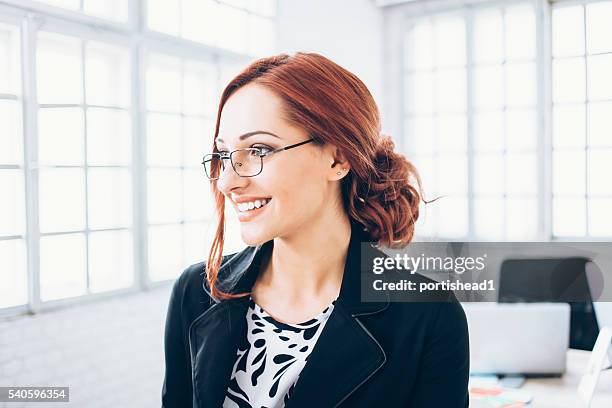 portrait of smiling young businesswoman - glasses side profile stock pictures, royalty-free photos & images