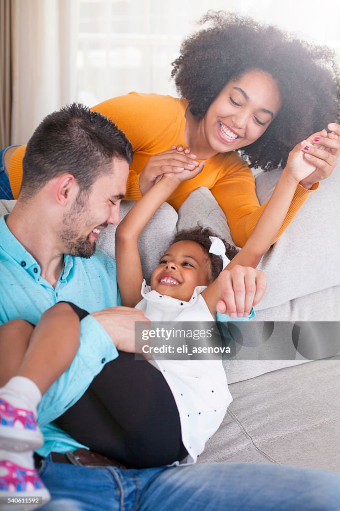 Playful young family at home.