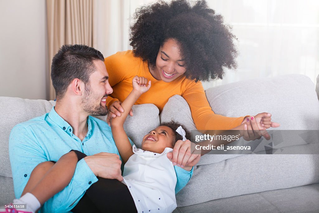 Playful young family at home.