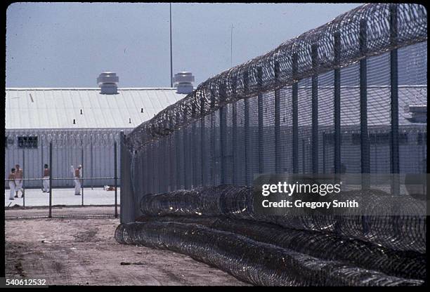 Fence of chain link and razor wire surrounds a prison in Beeville, Texas. The Chase Field Naval Air Station was converted to prison use after it...