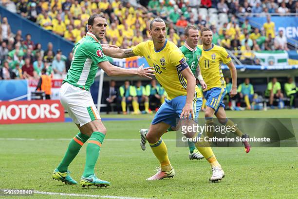 Zlatan Ibrahimovic of Sweden and John O"u2019Shea of Republic of Ireland compete for the ball during the UEFA EURO 2016 Group E match between...