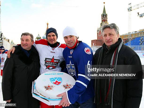 Soviet hockey superstars goalie Vladislav Tretiak and winger Alexander Yakushev pose for a photo with teams captains Jaromir Jagr and Alexey Yashin...