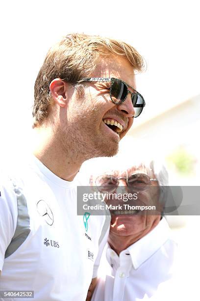 Nico Rosberg of Germany and Mercedes GP and F1 supremo Bernie Ecclestone talk in the Paddock during previews ahead of the European Formula One Grand...