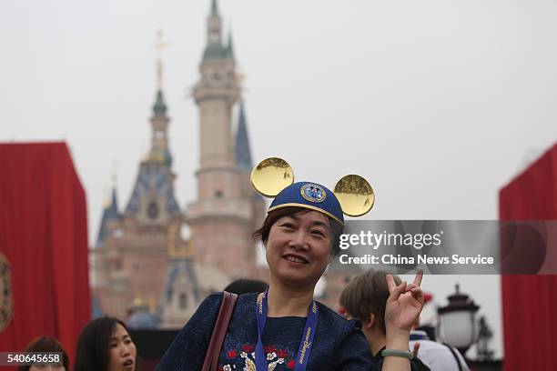 Woman wearing Mickey Mouse ears poses during the opening ceremony at Shanghai Disney Resort on June 16, 2016 in Shanghai, China. Shanghai Disney...