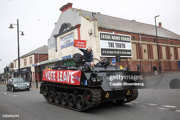 Darren Adamson, a "Vote Leave" campaigner, holds a "Vote Leave" placard as he rides in a modified FV432 armored personnel carrier, driven by Dale...