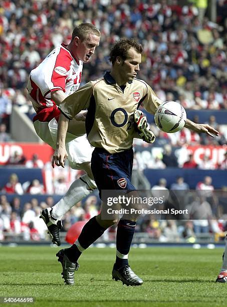 Freddie Ljungberg of Arsenal is challenged by John Curtis of Sheffield United during the FA Cup Semi-Final between Arsenal and Sheffield United on...
