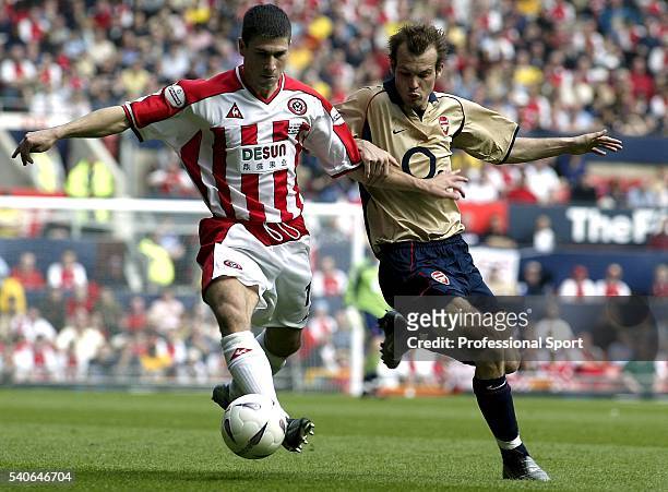 Freddie Ljungberg of Arsenal challenges Nick Montgomery of Sheffield United during the FA Cup Semi-Final between Arsenal and Sheffield United on...