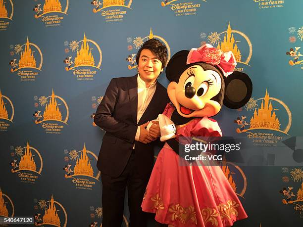 Pianist Lang Lang poses with Minnie Mouse at Shanghai Disney Resort ahead of the opening ceremony on June 15, 2016 in Shanghai, China.