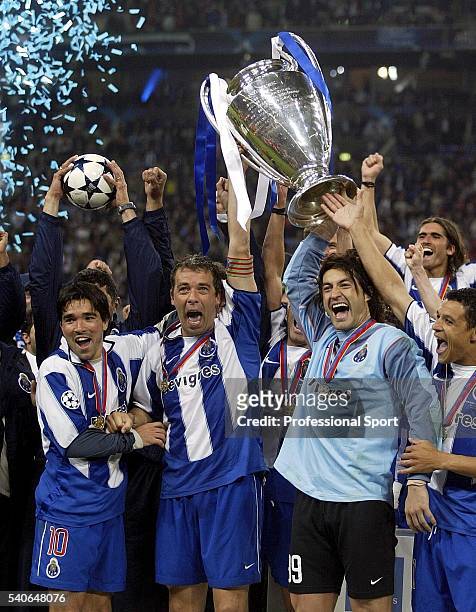 Porto captain Jorge Costa lifts the European Champions Cup with Deco and Vitor Baia after winning the UEFA Champions League Final match between AS...