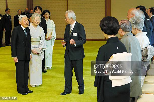 Emepror Akihito and Empress Michiko greet guests at the tea party inviting Japan Art Academy Award laureates at the Imperial Palace on June 13, 2016...