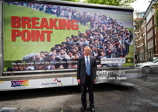 Leader of the United Kingdom Independence Party Nigel Farage poses with the party's new EU referendum poster in Westminster on June 16, 2016 in...