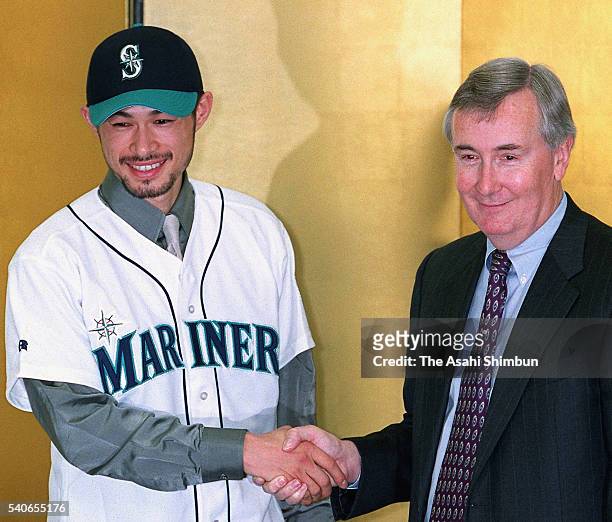 Ichiro Suzuki and Howard Lincoln, Seattle's chief executive celebrate Suzuki joining the MLB and signing a three-year contract with the Seattle...