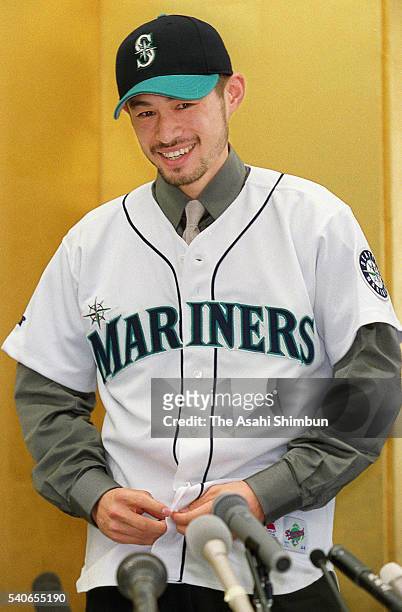 Ichiro Suzuki celebrates joining the MLB and signing a three-year contract with the Seattle Mariners in his uniform during the press conference on...