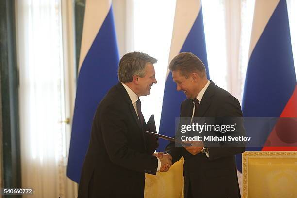 Russian Gazprom's CEO Alexei Miller greets Royal Dutch Shell CEO Ben van Beurden at the Konstantin Palace on June 16, 2016 in Saint Petersburg,...