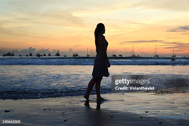 woman walking  on the beach at sunset, nicaragua - san juan del sur bildbanksfoton och bilder