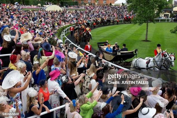 Britain's Queen Elizabeth II and Britain's Prince Philip, Duke of Edinburgh arrive by carriage on Ladies Day of the Royal Ascot horse racing meet in...