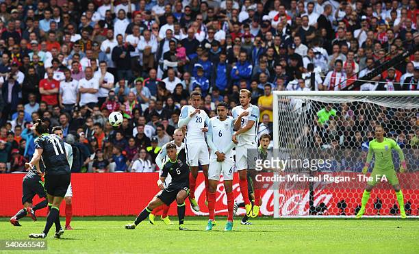 Gareth Bale of Wales scores his team's first goal from a free kick during the UEFA EURO 2016 Group B match between England and Wales at Stade...
