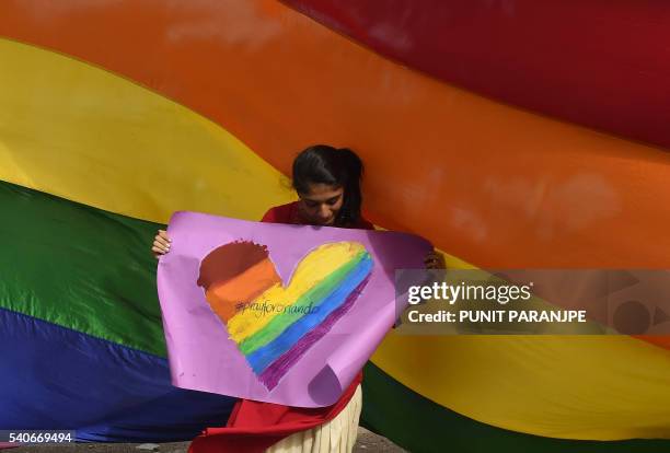 Member of the Indian LGBT community attends a vigil in Mumbai on June 16 in solidarity with the victims of the Orlando mass shooting. Forty-nine...