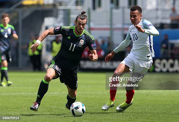 Dele Alli of England in action against Gareth Bale of Wales during the UEFA Euro 2016 Group B match between England and Wales at Stade...