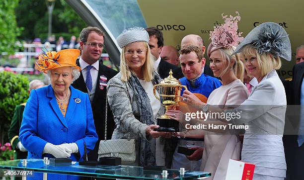 Queen Elizabeth II presents the trophy to Jockey Ryan Moore and connections after guiding Order of St George to victory in the Gold Cup in Honour of...