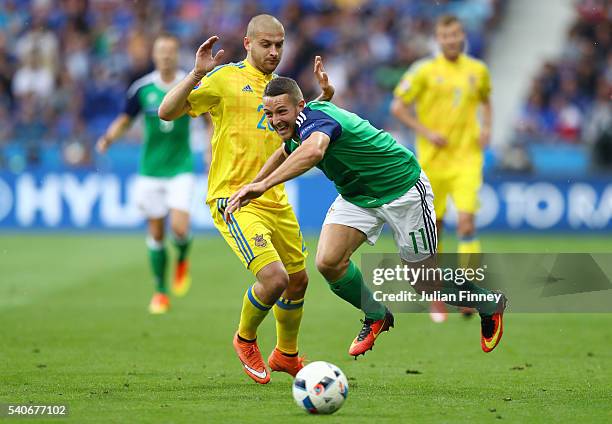 Craig Cathcart of Northern Ireland and Yaroslav Rakitskiy of Ukraine compete for the ball during the UEFA EURO 2016 Group C match between Ukraine and...