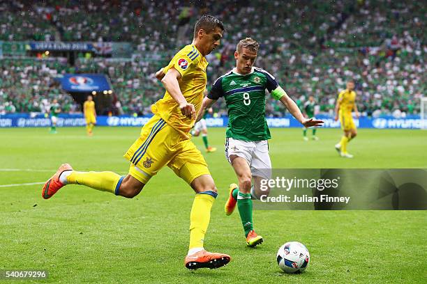 Yevhen Khacheridi of Ukraine and Steven Davis of Northern Ireland compete for the ball during the UEFA EURO 2016 Group C match between Ukraine and...