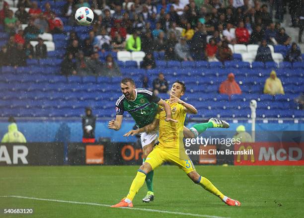 Gareth McAuley of Northern Ireland heads the ball to score his team's first goal during the UEFA EURO 2016 Group C match between Ukraine and Northern...