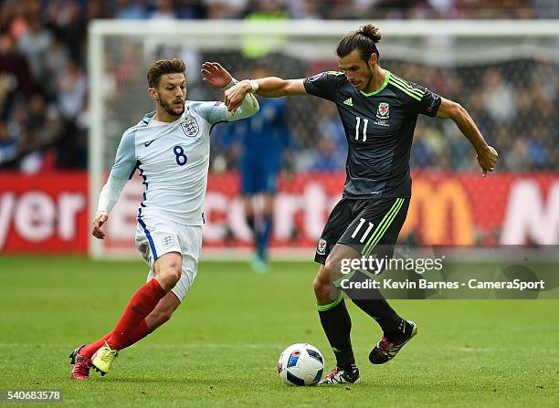 Wales's Gareth Bale under pressure from England's Adam Lallana during the UEFA Euro 2016 Group B match between England and Wales at Stade...