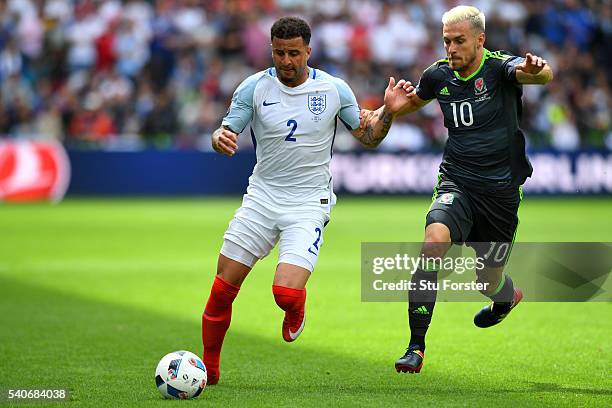 Kyle Walker of England bursts past Aaron Ramsey of Wales during the UEFA Euro 2016 Group B match between England and Wales at Stade Bollaert-Delelis...