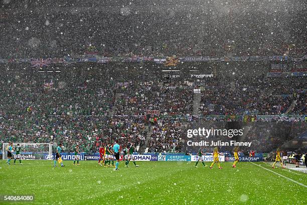 Players leave the pitch due to the adverse weather condition during the UEFA EURO 2016 Group C match between Ukraine and Northern Ireland at Stade...