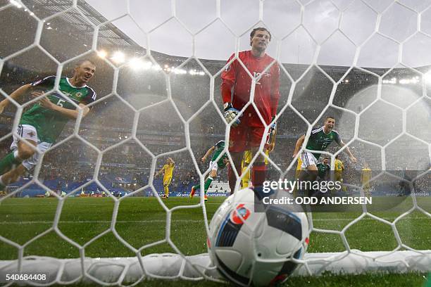 Northern Ireland's defender Jonny Evans celebrates the opening goal scored by Northern Ireland's defender Gareth McAuley past Ukraine's goalkeeper...