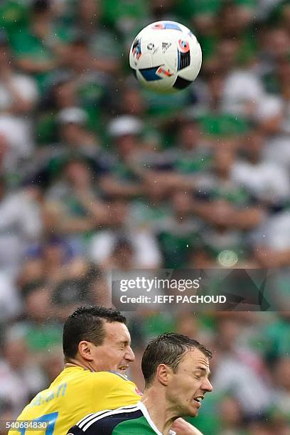 Ukraine's defender Artem Fedetskiy and Northern Ireland's defender Jonny Evans vie for the ball during the Euro 2016 group C football match between...