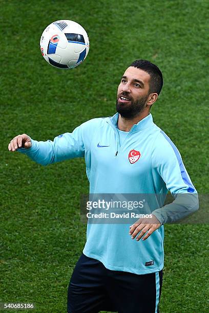 Arda Turan of Turkey juggles the ball during a training session ahead of their UEFA Euro 2016 Group D match against Spain at Allianz Riviera Stadium...