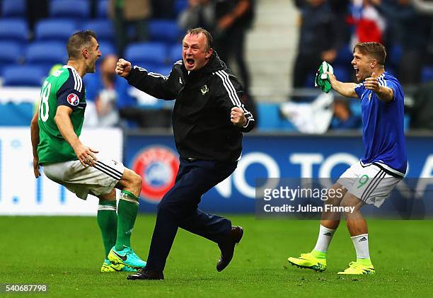 Michael O'Neill manager of Northern Ireland celebrate his team's second goal with Aaron Hughes and Jamie Ward during the UEFA EURO 2016 Group C match...