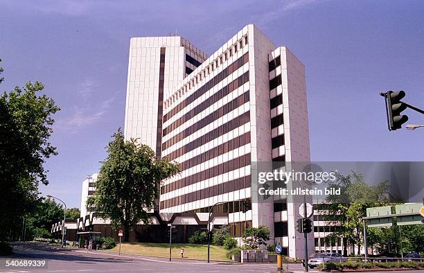 Das Gebäude der Ruhrgas AG in der Huttropstraße in Essen. Neben dem Haus befinden sich Bäume und davor eine Straßenkreuzung. Rechts hängt eine Ampel....