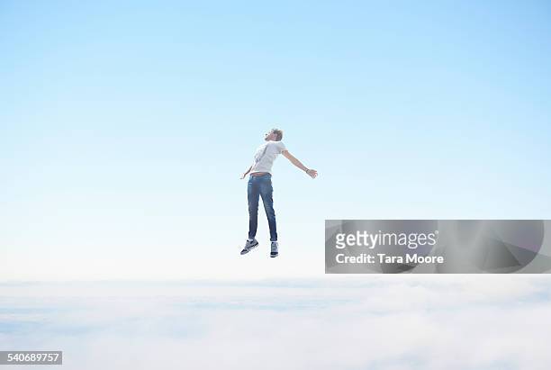 man floating in sky - freiheit stock-fotos und bilder