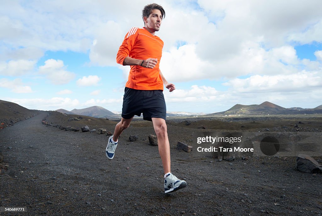 Male Runner in barren landscape