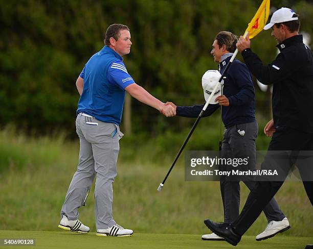 Robert MacIntyre of Glencruitten shakes hands with David Micheluzzi of Australia after winning his match during The Amateur Championship 2016 - Day...