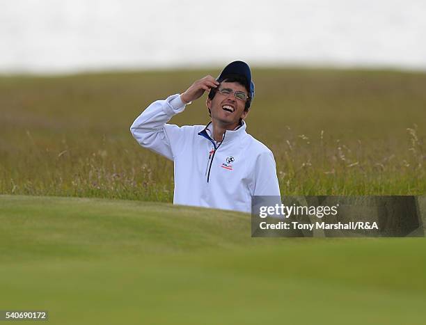 Javier Sainz of Spain reacts after taking four shots to get out of a bunker on the 17th green during The Amateur Championship 2016 - Day Four at...