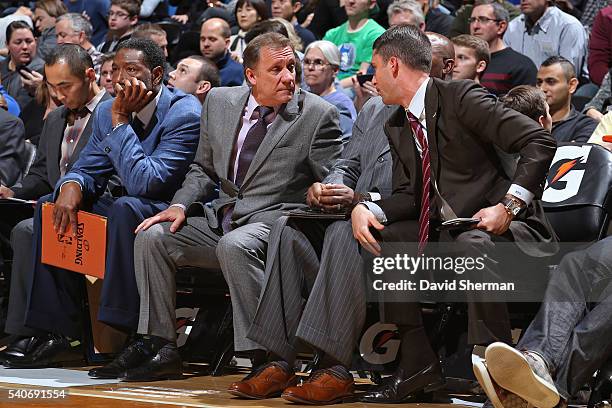 Flip Saunders and Ryan Saunders of the Minnesota Timberwolves talk on the bench during the game against the San Antonio Spurs on November 21, 2014 at...