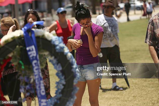 Woman visits a memorial for those killed in the Pulse nightclub shooting on June 16, 2016 in Orlando, Florida. Omar Mir Seddique Mateen, reportedly...