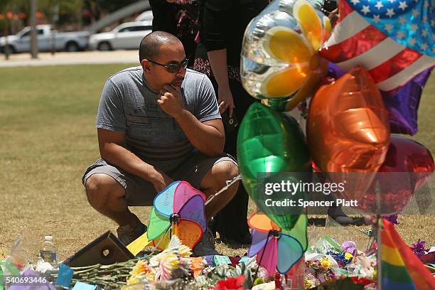 Man visits a memorial for those killed in the Pulse nightclub shooting on June 16, 2016 in Orlando, Florida. Omar Mir Seddique Mateen, reportedly...