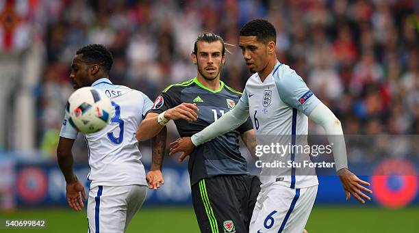 Chris Smalling and Danny Rose of England challenge Gareth Bale of Wales during the UEFA Euro 2016 Group B match between England and Wales at Stade...