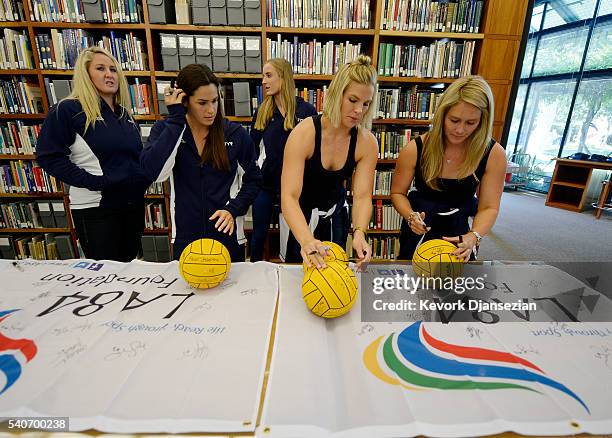 Rachel Fattal Kami Craig and Courtney Mathewson, members of 2016 U.S. Olympic Women's Water Polo Team, signs water polo balls during a ceremony where...