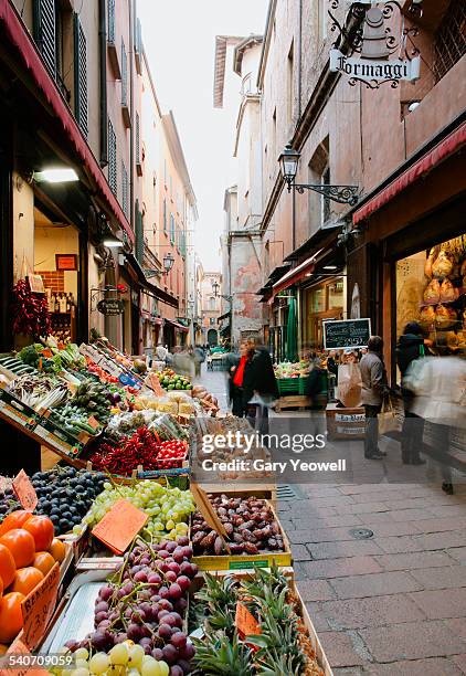 traditional food shops in narrow cobbled street - bologna foto e immagini stock