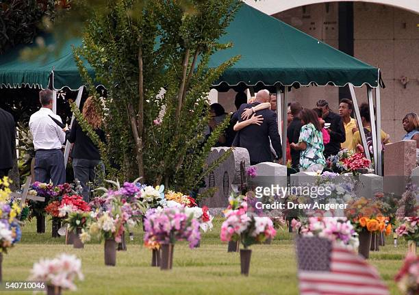 After the viewing and funeral service, mourners gather at the burial site for Kimberly Morris, June 16, 2016 in Kissimmee, Florida. Morris, who...