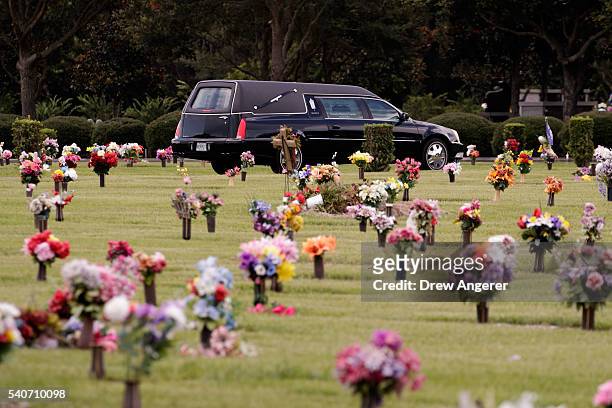 Hearse that carried the body of Kimberly Morris drives through the cemetery after the burial for Morris, June 16, 2016 in Kissimmee, Florida. Morris,...