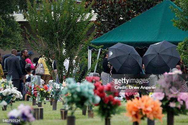 After the viewing and funeral service, mourners gather at the burial site for Kimberly Morris, June 16, 2016 in Kissimmee, Florida. Morris, who...