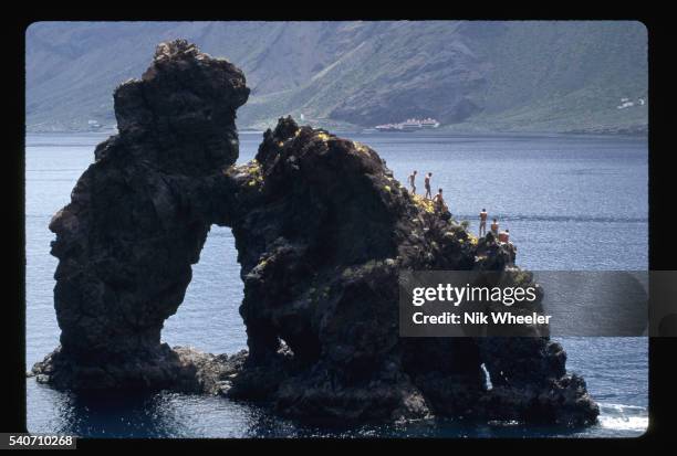 People climb on the Roque De La Bonanza at Playa De La Arena on El Hierro Island. Canary Isles, Spain. | Location: El Hierro Island, Canary Isles,...